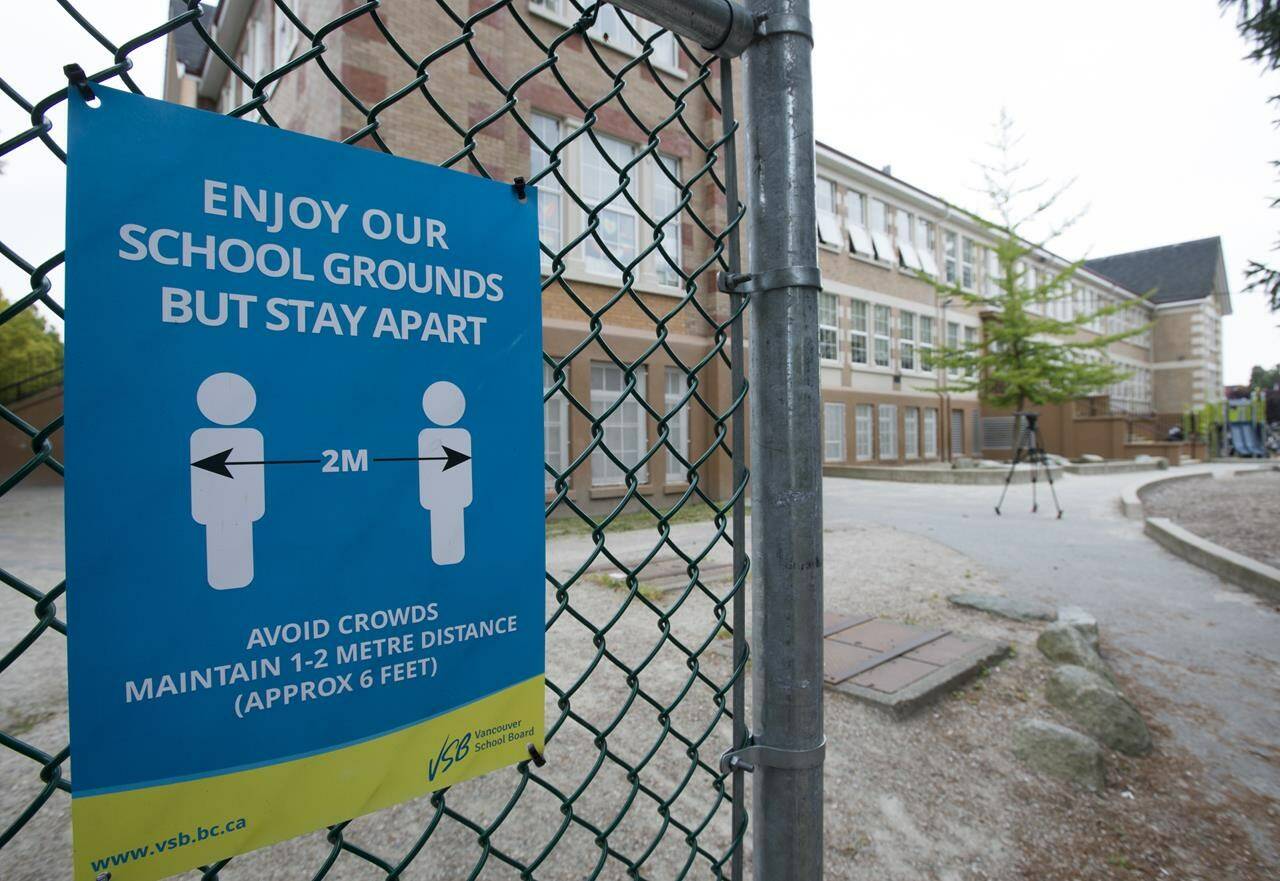 FILE – A physical distancing sign is seen during a media tour of Hastings Elementary school in Vancouver on Sept. 2, 2020. THE CANADIAN PRESS/Jonathan Hayward