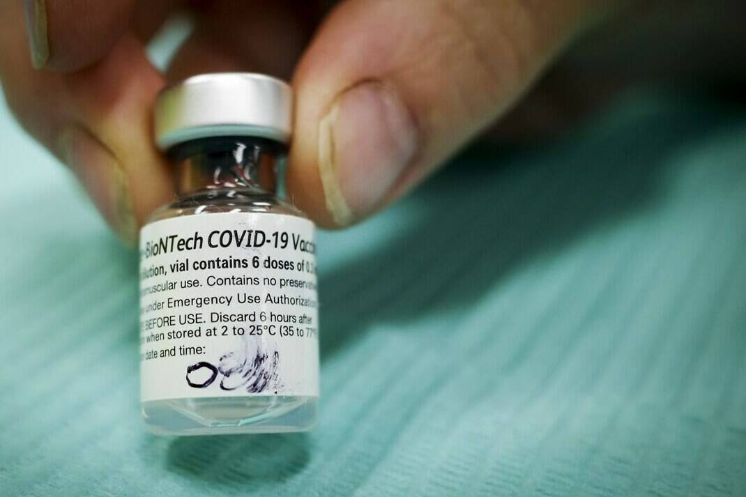 A vial of Pfizer-BioNTech COVID-19 vaccine is pictured at an Alberta Health Services vaccination clinic in Didsbury, Alta., Tuesday, June 29, 2021. THE CANADIAN PRESS/Jeff McIntosh