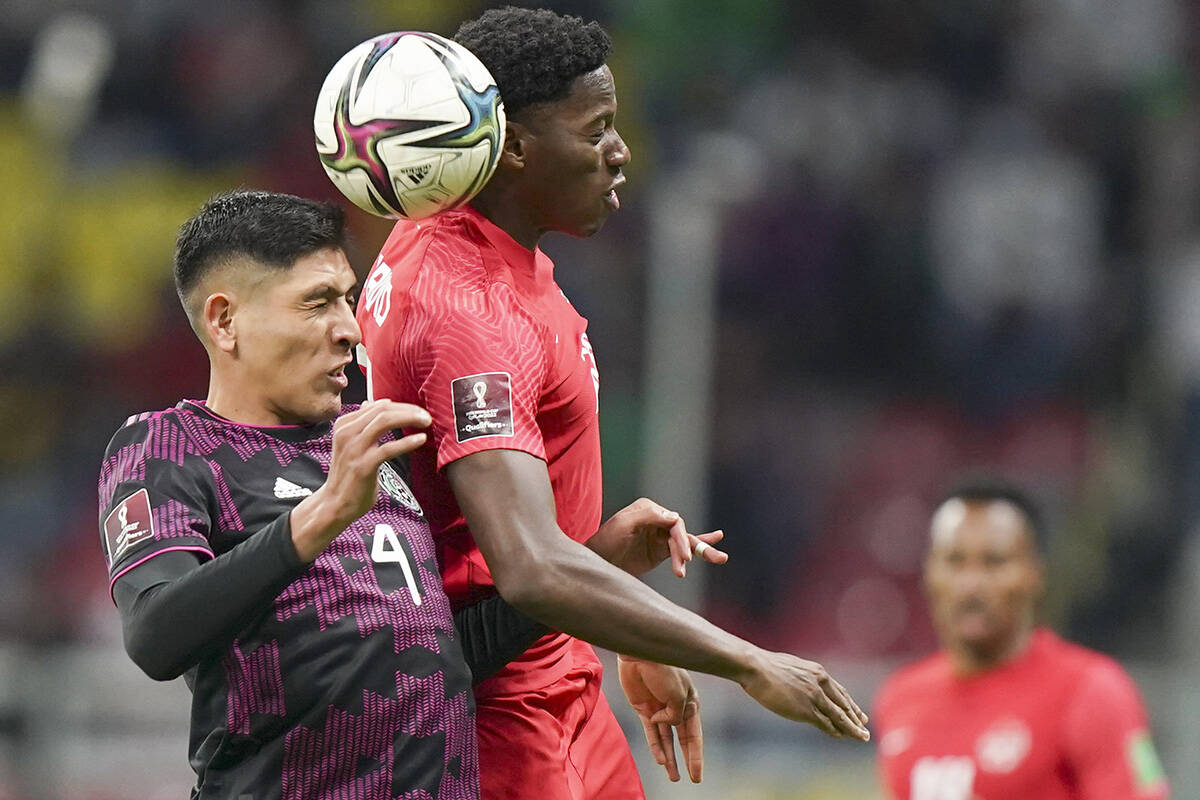 Canada’s Jonathan David, right, and Mexico’s Edson Alvarez go for a header during a qualifying soccer match for the FIFA World Cup Qatar 2022 in Mexico City, Thursday, Oct. 7, 2021. (AP Photo/Fernando Llano)