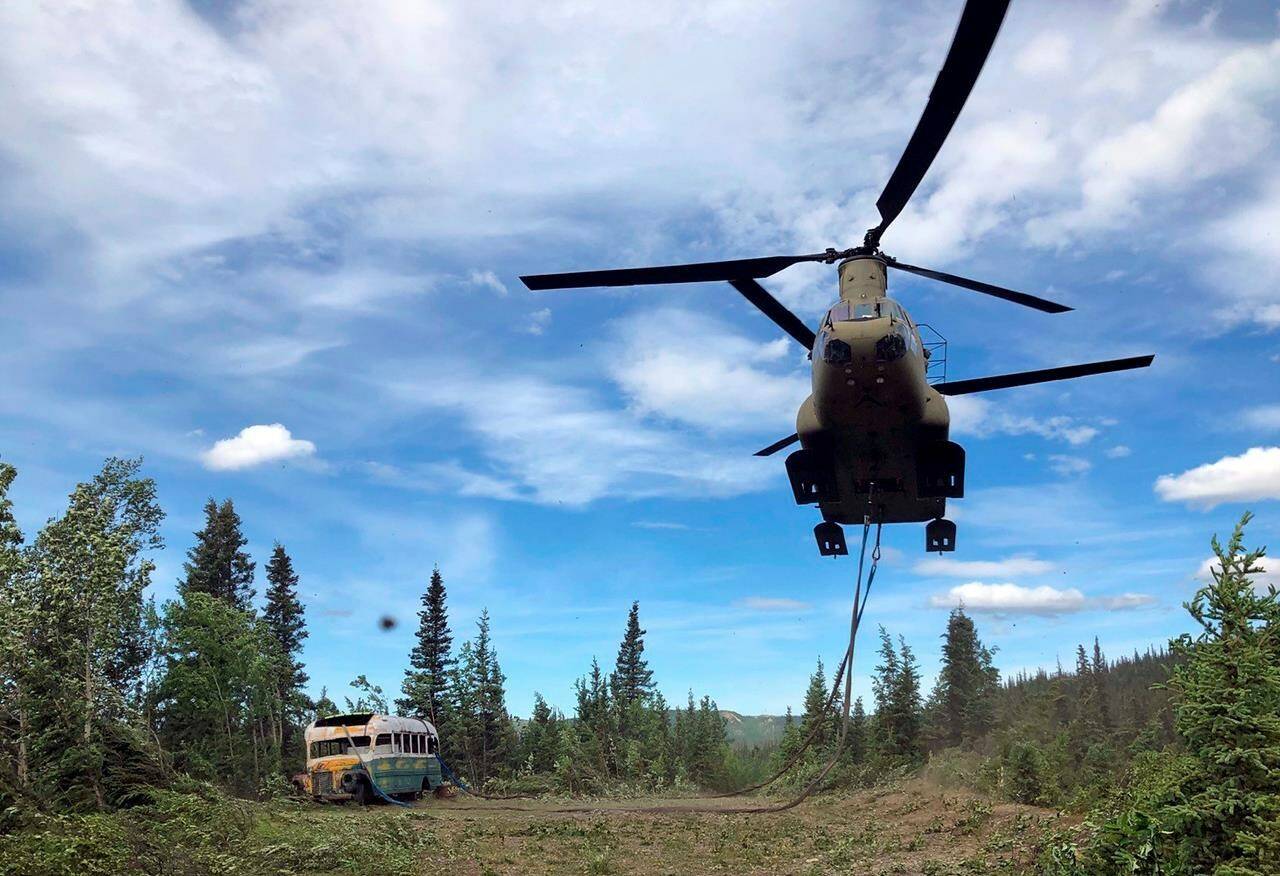 FILE - In this June 18, 2020, file photo released by the Alaska National Guard, Alaska Army National Guard soldiers use a CH-47 Chinook helicopter to removed an abandoned bus, popularized by the book and movie “Into the Wild,” out of its location in the Alaska backcountry as part of a training mission. The bus that once lured people on sometimes deadly pilgrimages to Alaska’s backcountry can now safely be viewed at the University of Alaska Fairbanks while it undergoes preservation work. The bus was moved to the University’s Engineering facility in early Oct. 2021, while it’s being prepared for outdoor display at the Museum of the North, Fairbanks television station KTVF reported. (Sgt. Seth LaCount/Alaska National Guard via AP, File)