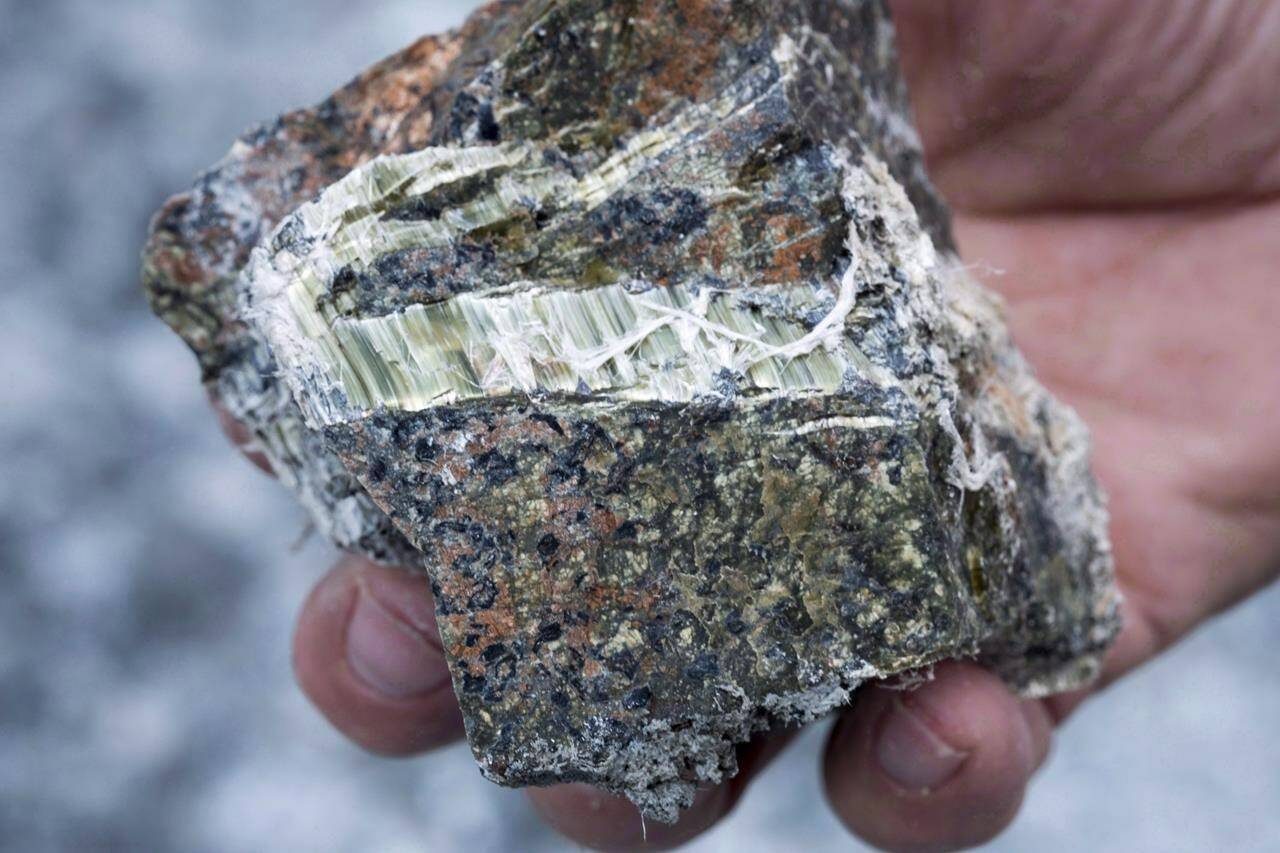 A chunk of asbestos is displayed in Asbestos, Que., in an August 10, 2016, file photo. A group of doctors and environment advocates say the Liberals need to close a loophole that is allowing the resale of second-hand products containing asbestos. THE CANADIAN PRESS/Paul Chiasson