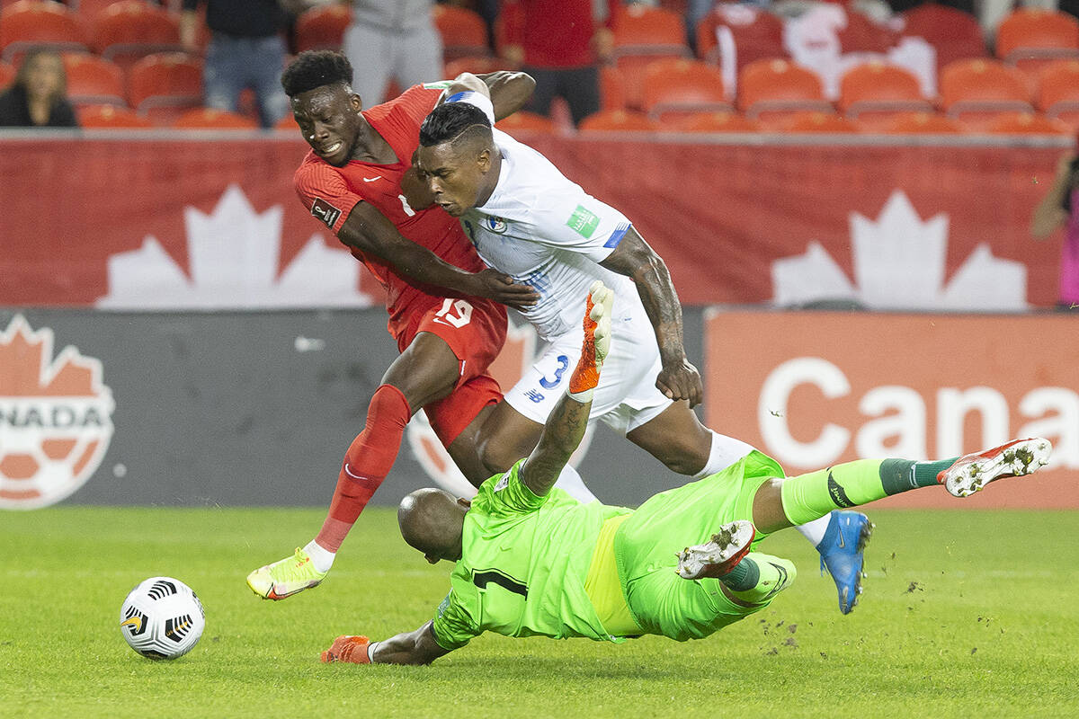 Canada’s Alphonso Davies (left) runs around Panama goalkeeper Luis Mejia as Harold Cummings looks on during first half World Cup qualifying action in Toronto, on Wednesday, October 13, 2021. THE CANADIAN PRESS/Chris Young