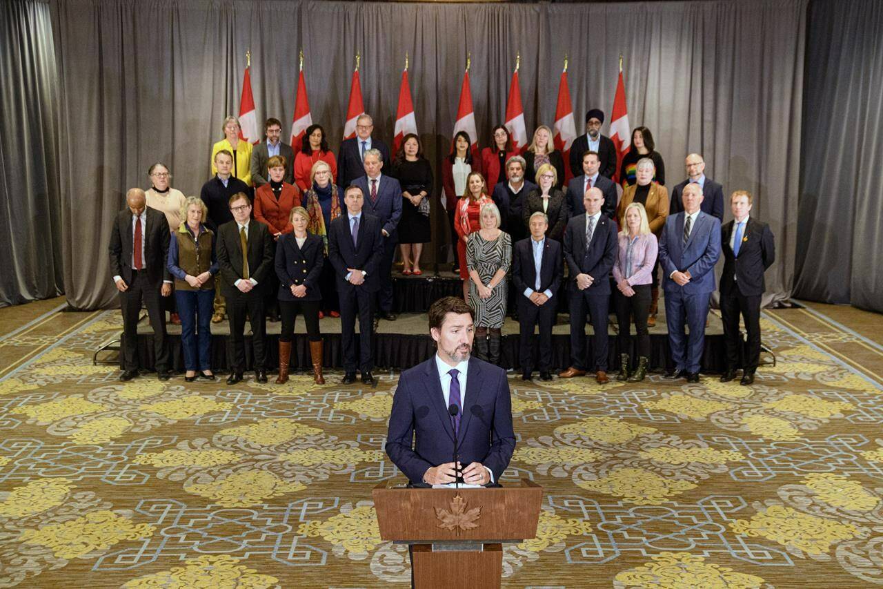 Prime Minister Justin Trudeau stands in front of his cabinet as he speaks to media during the final day of the Liberal cabinet retreat at the Fairmont Hotel in Winnipeg, Tuesday, Jan. 21, 2020. THE CANADIAN PRESS/Mike Sudoma