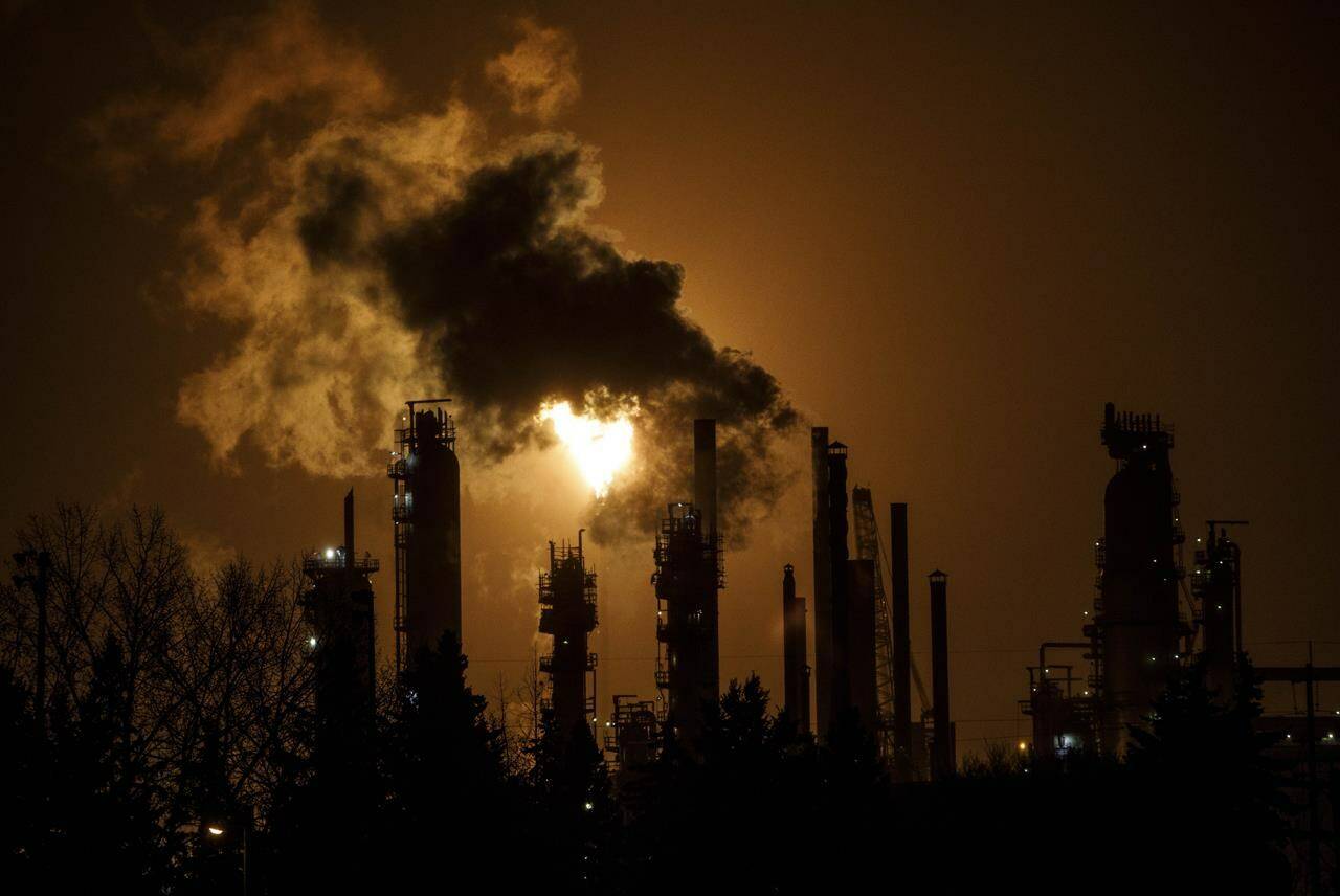 A flare stack lights the sky from an oil refinery in Edmonton on December 28, 2018. THE CANADIAN PRESS/Jason Franson