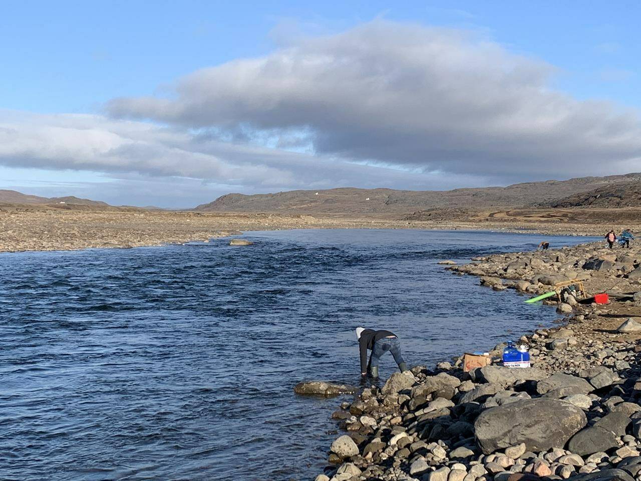 Residents collect water from the Sylvia Grinnell River near Iqaluit, Nunavut on Wednesday, Oct. 13, 2021. THE CANADIAN PRESS/Emma Tranter