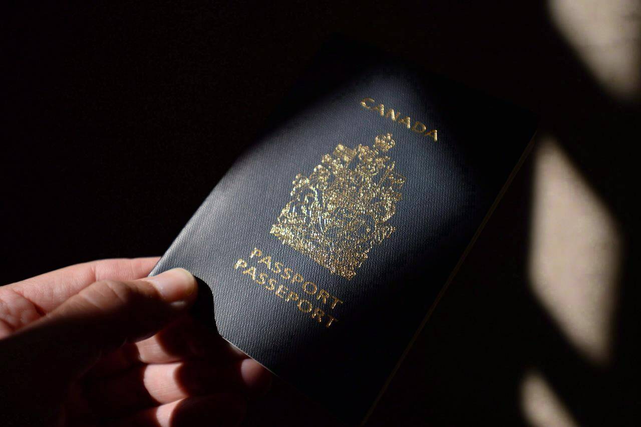 A Canadian passport is displayed in Ottawa on July 23, 2015. Canadian officials are bracing for a potential onslaught of passport renewals now that the border between Canada and the U.S. is poised to reopen. THE CANADIAN PRESS/Sean Kilpatrick