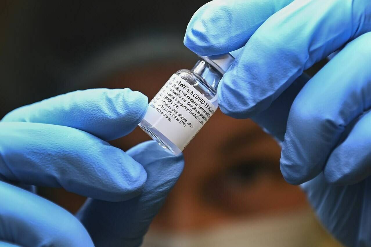 FILE – A health-care worker prepares a dose of the Pfizer-BioNTech COVID-19 vaccine at a UHN COVID-19 vaccine clinic in Toronto on Thursday, January 7, 2021. THE CANADIAN PRESS/Nathan Denette