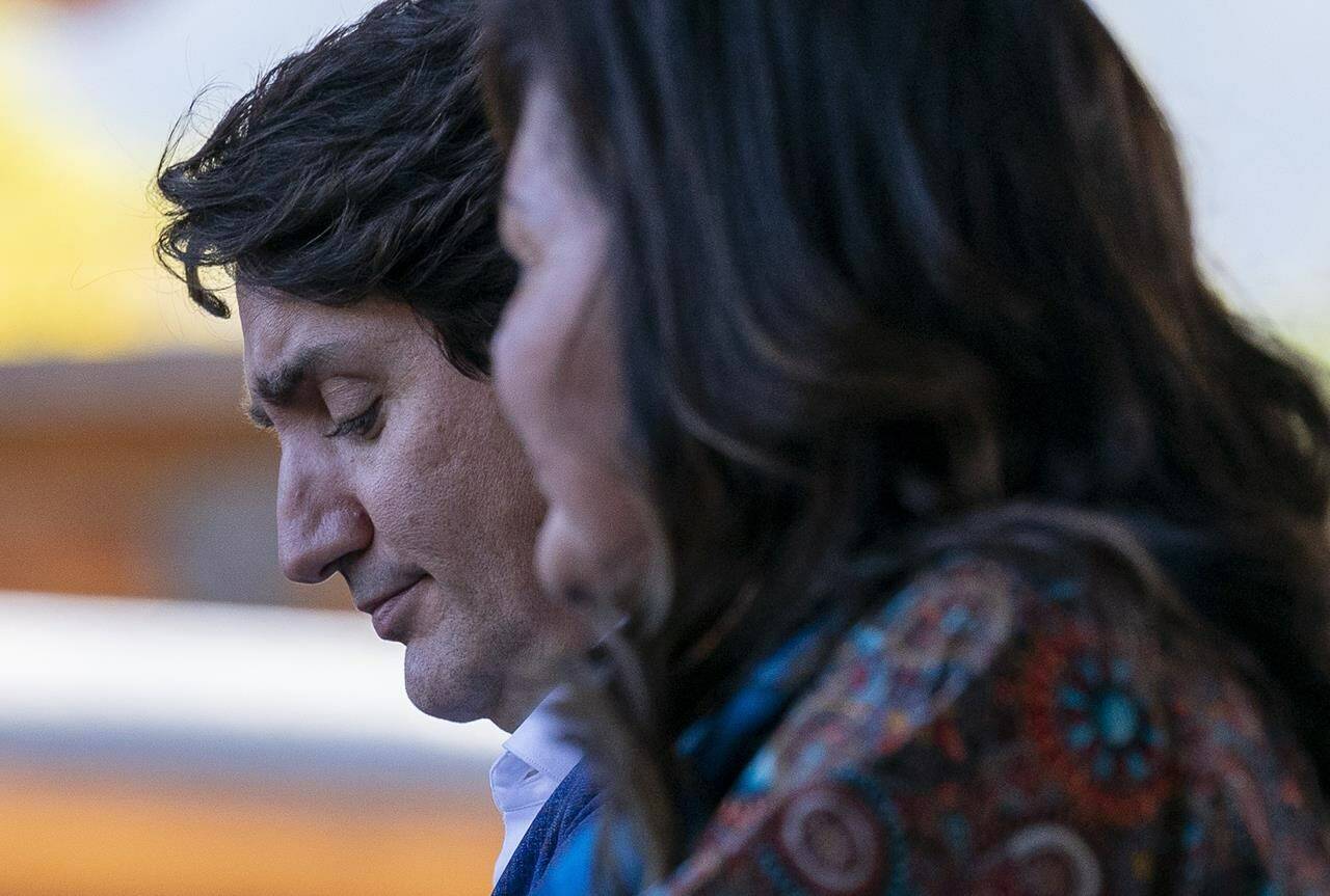 Prime Minister Justin Trudeau bows his head as he listens to chief Rosanne Casimir at Tk’emlups the Sewepemc in Kamloops, B.C. Monday, Oct. 18, 2021. THE CANADIAN PRESS/Jonathan Hayward