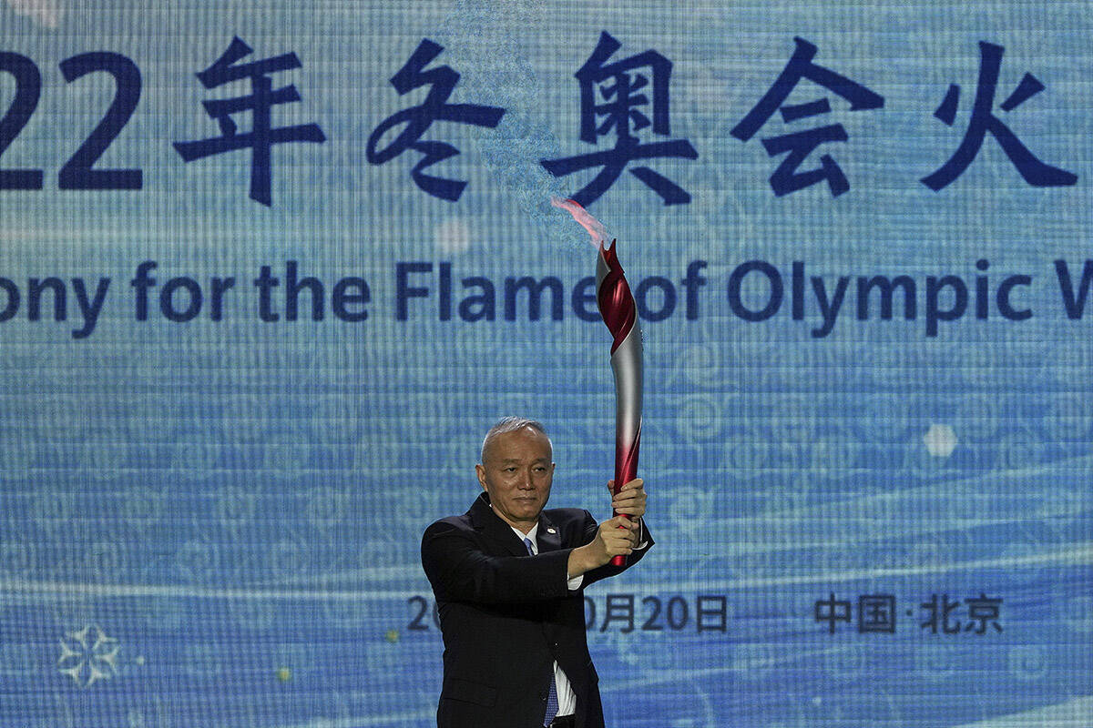 Cai Qi, Beijing Communist Party secretary holds up the Olympic torch during a welcome ceremony for the Frame of Olympic Winter Games Beijing 2022, at the Olympic Tower in Beijing, Wednesday, Oct. 20, 2021. A welcome ceremony for the Olympic flame was held in Beijing on Wednesday morning after it arrived at the Chinese capital from Greece. While the flame will be put on display over the next few months, organizers said a three-day torch relay is scheduled starting February 2nd with around 1200 torchbearers in Beijing, Yanqing and Zhangjiakou. (AP Photo/Andy Wong)