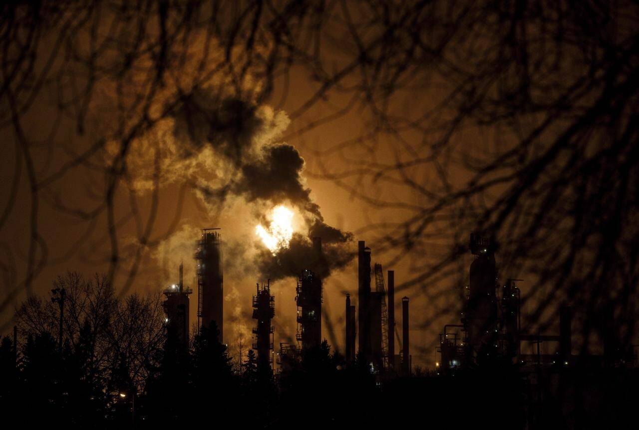 A flare stack lights the sky along refinery row in Edmonton on Friday December 28, 2018. THE CANADIAN PRESS/Jason Franson