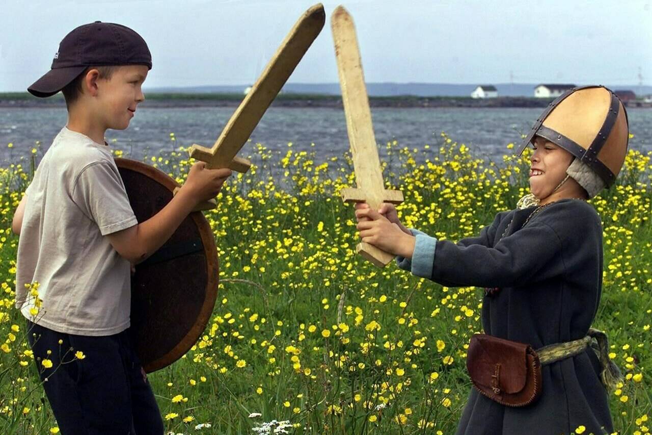 Justin Mercer, left, of Griquet-St.Lunaire, Nfld., battles with Matthew Scott of Fairfax, Virginia, also known as the Viking boy, Ivar, in L’Anse aux Meadows, N.L., Friday July 28, 2000. A groundbreaking study has confirmed Vikings settled in remote corner of northern Newfoundland in AD 1021, marking with scientific certainty the first time Europeans arrived in the Americas — exactly 1,000 years ago. THE CANADIAN PRESS/Andrew Vaughan