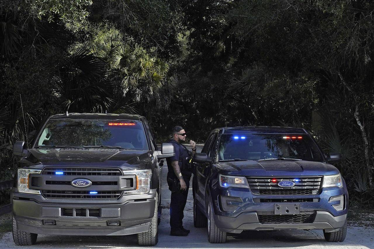 North Port, Fla., police officers block the entrance to the Myakkahatchee Creek Environmental Park Wednesday, Oct. 20, 2021, in North Port, Fla. Items believed to belong to Brian Laundrie and potential human remains were found in a Florida wilderness park during a search for clues in the slaying of Gabby Petito . (AP Photo/Chris O’Meara)