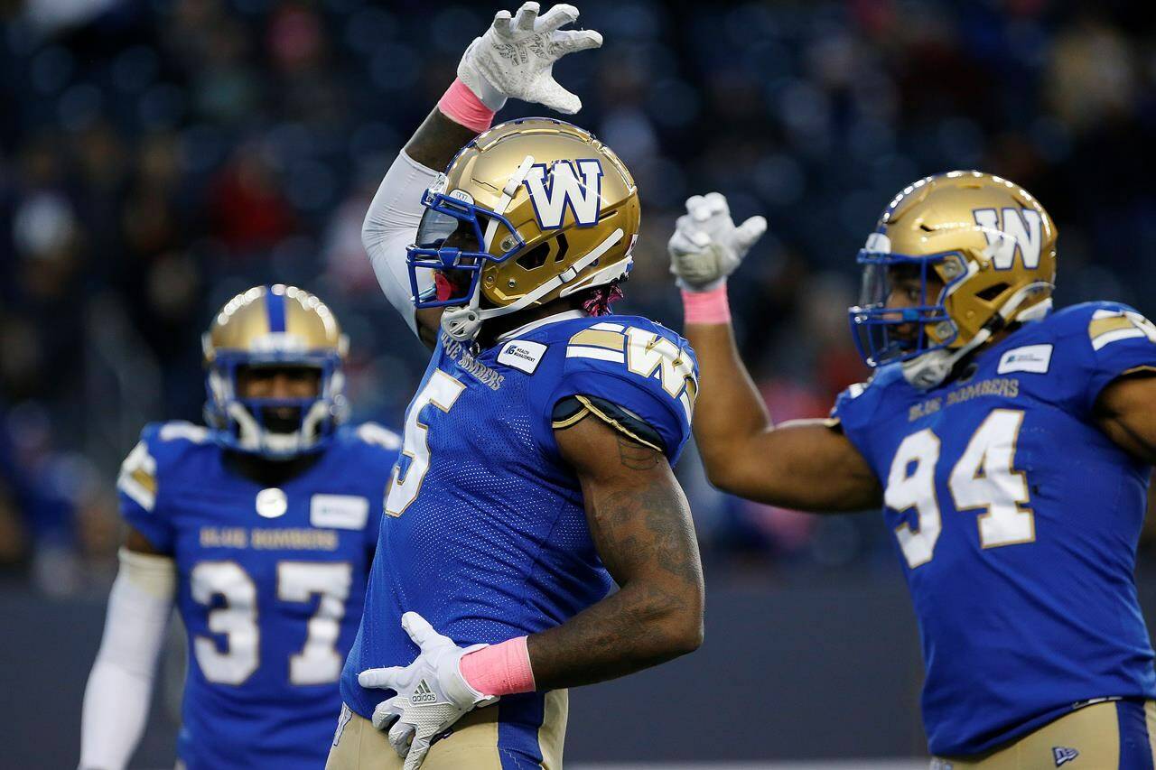 Winnipeg Blue Bombers’ Willie Jefferson (5) and Jackson Jeffcoat (94) celebrate their sack of B.C. Lions quarterback Mike Reilly (not shown) during the first half of CFL action in Winnipeg Saturday, October 23, 2021. THE CANADIAN PRESS/John Woods