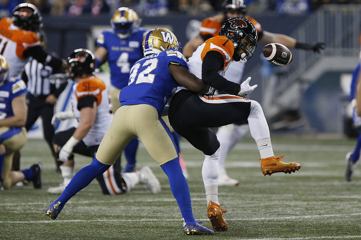 Winnipeg Blue Bombers’ Deatrick Nichols (32) knocks the ball away from B.C. Lions’ Lemar Durant (1) as he attempts the catch during the first half of CFL action in Winnipeg Saturday, October 23, 2021. THE CANADIAN PRESS/John Woods