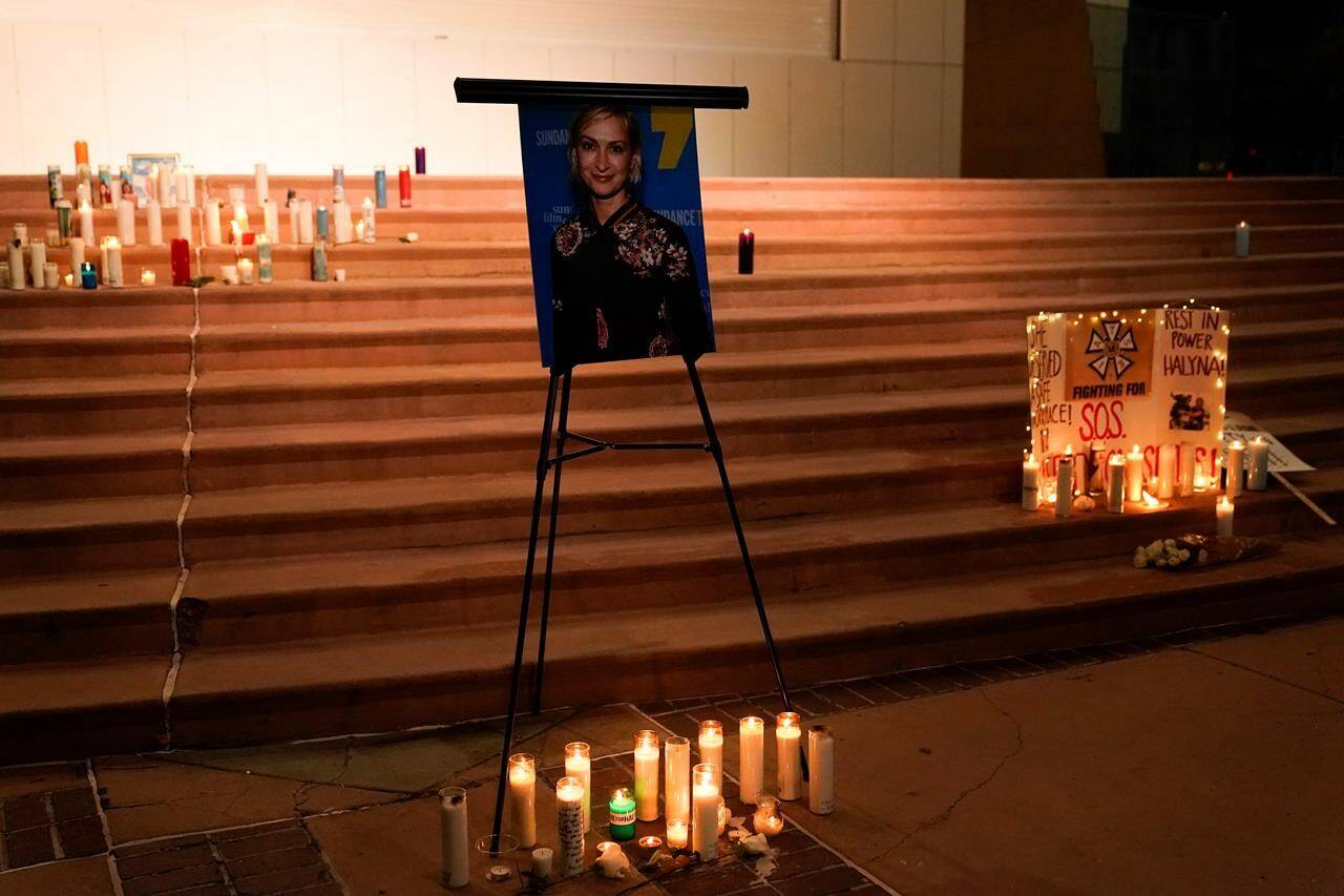 Candles are lit around a photo of cinematographer Halyna Hutchins during a candlelight vigil in Albuquerque, N.M., Saturday, Oct. 23, 2021. Hutchins died on Thursday after she was fatally shot by actor Alec Baldwin with a prop gun on a New Mexico film set. THE CANADIAN PRESS/AP, Jae C. Hong