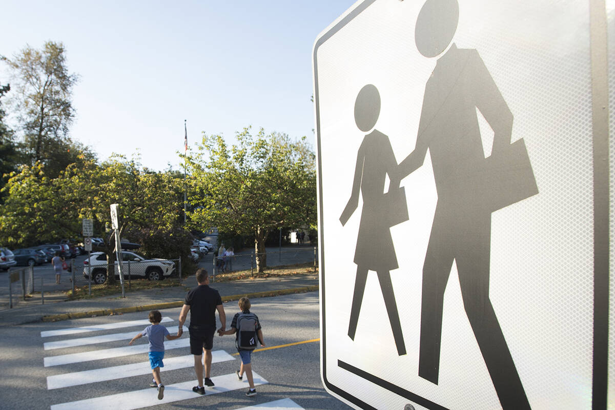 FILE – Children walk with their parents to Sherwood Park Elementary in North Vancouver for the first day back-to-school Thursday, September 10, 2020. THE CANADIAN PRESS/Jonathan Hayward