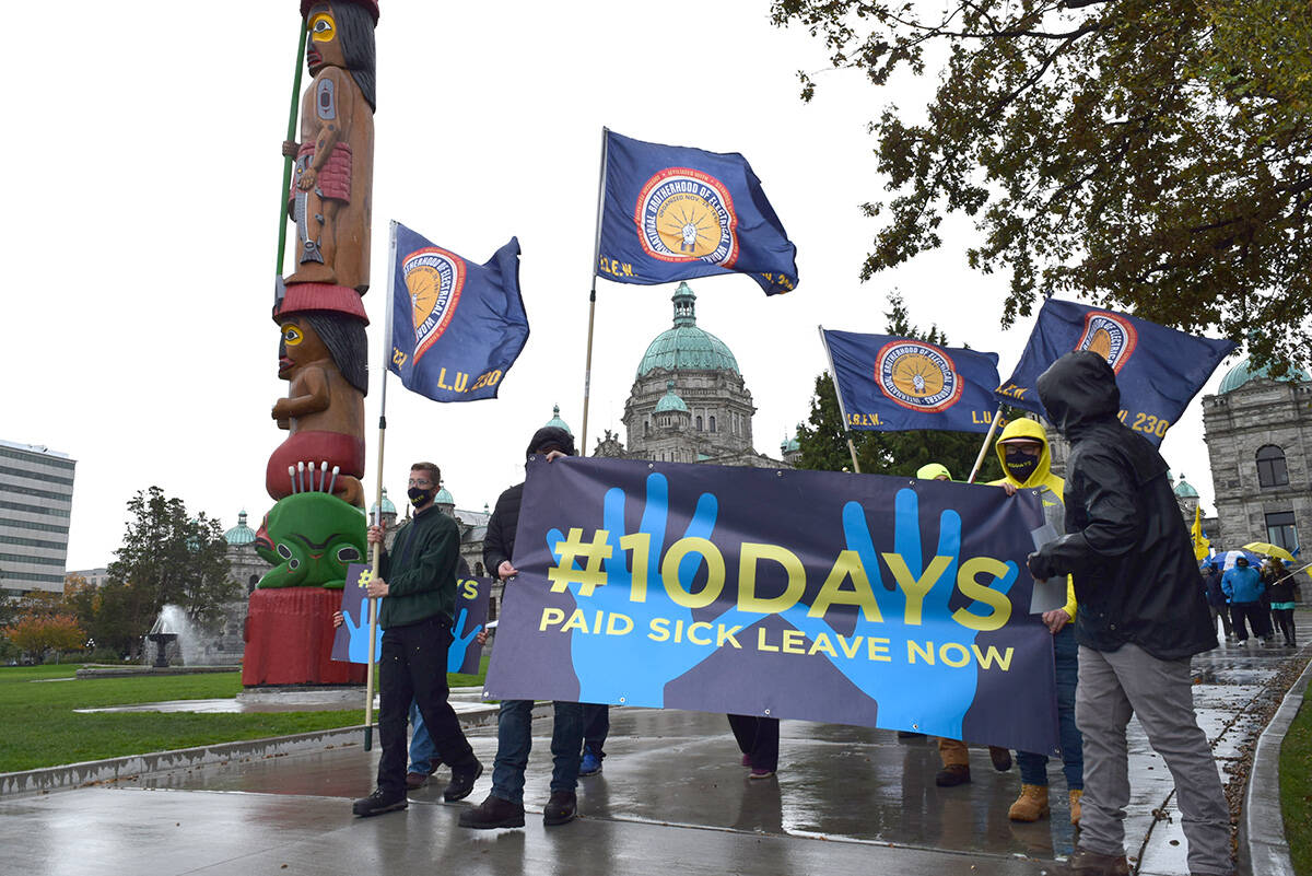 Demonstrators in favour of 10 paid sick leave days march away from the B.C. Legislature in Victoria, doing a lap before ending their demonstration. (Kiernan Green/News Staff)