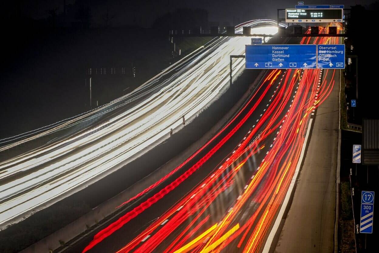 In this long time exposure photo, trucks and cars roll on a highway in Frankfurt, Germany, Tuesday, Oct. 26, 2021. (AP Photo/Michael Probst)