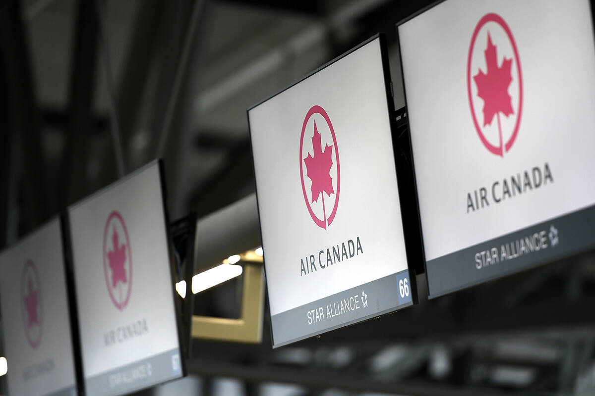 FILE - This May 16, 2020 file photo shows Air Canada check screens at Ottawa International Airport in Ottawa, Ontario, Canada. (Justin Tang/The Canadian Press via AP)