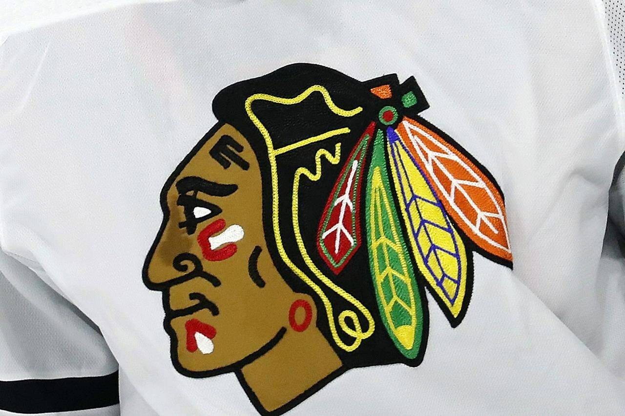 FILE - In this May 3, 2021, file photo, the Chicago Blackhawks logo is displayed on a jersey in Raleigh, N.C. The Blackhawks are holding a briefing Tuesday, Oct. 26, 2021, to discuss the findings of an investigation into allegations that an assistant coach sexually assaulted a player in 2010. (AP Photo/Karl B DeBlaker, File)