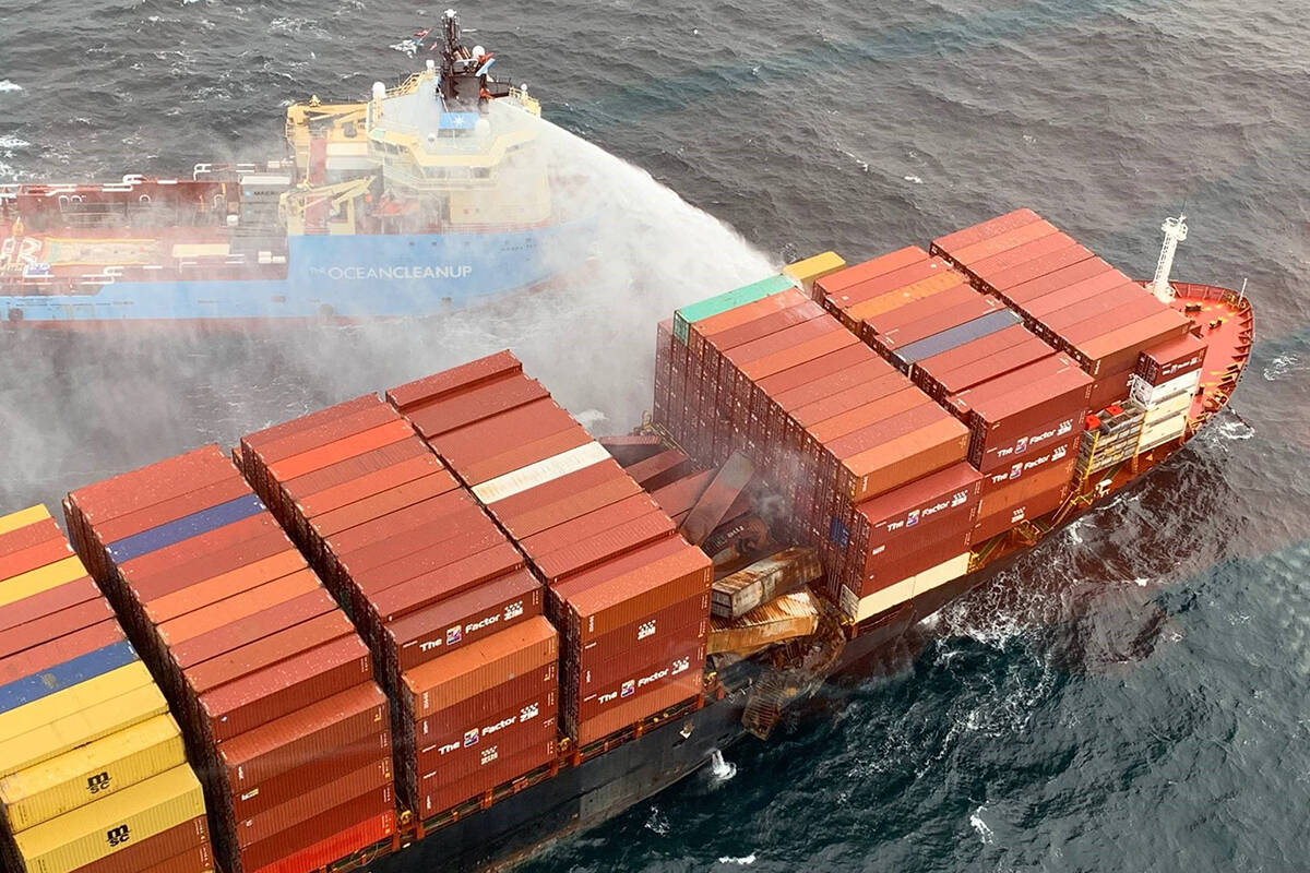 Crews keep surrounding containers and the hull of the MV Zim Kingston cool while fires continue to smoulder aboard the ship. (Canadian Coast Guard/Twitter)