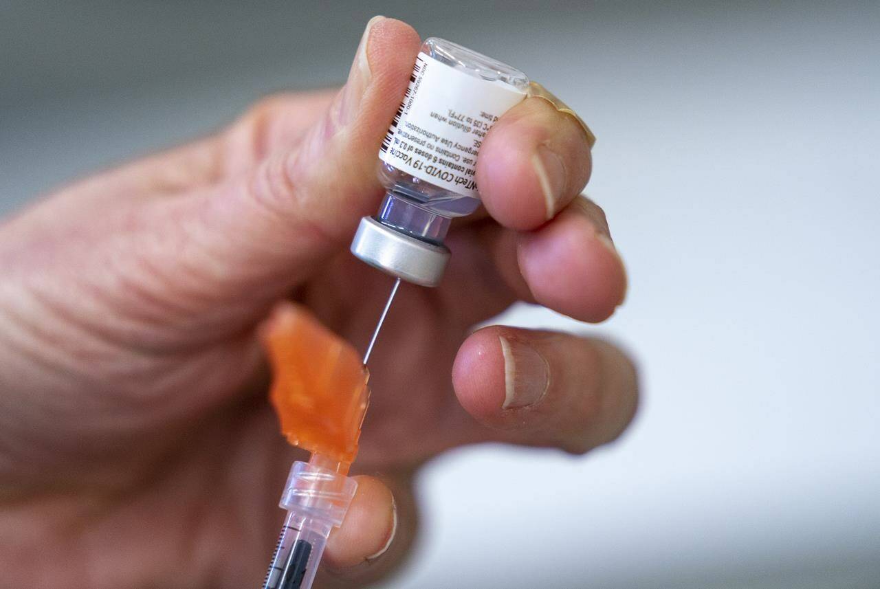 FILE – A syringe is loaded with COVID-19 vaccine at a vaccination clinic run by Vancouver Coastal Health, in Richmond, B.C., Saturday, April 10, 2021. (Canadian Press photo)