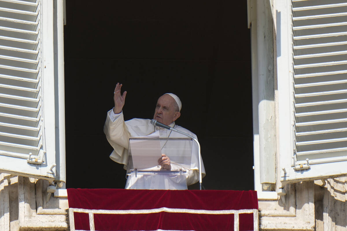 Pope Francis blesses faithful during the Angelus noon prayer he delivers from the window of his studio overlooking St. Peter’s Square at the Vatican, Sunday, Oct. 17, 2021. (AP Photo/Alessandra Tarantino)
