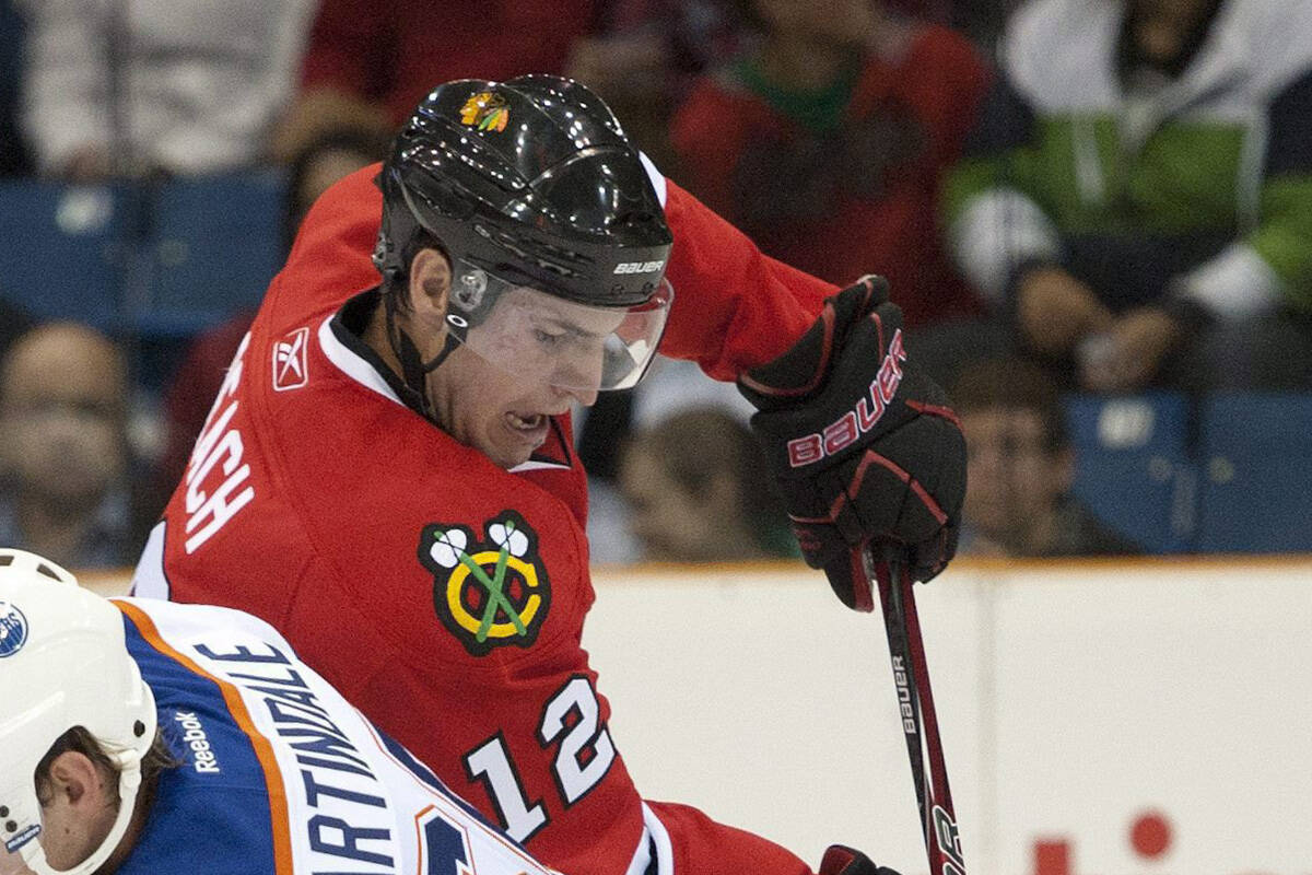 Chicago Blackhawks forward Kyle Beach, right, gets the puck past Edmonton Oilers centre Ryan Martindale during the first period of an NHL pre-season hockey game in Saskatoon on Tuesday, Sept 20, 2011. THE CANADIAN PRESS/Liam Richards