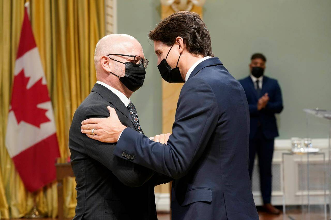 Prime Minister Justin Trudeau, right, congratulates David Lametti, minister of justice and attorney general of Canada, during a cabinet swearing-in ceremony at Rideau Hall in Ottawa on October 26, 2021. Canada's attorney general says that with only days to go until the court deadline, the Liberal cabinet still has not decided whether or not to appeal a decision that would see the government pay out billions of dollars in compensation to Indigenous families. THE CANADIAN PRESS/Adrian Wyld