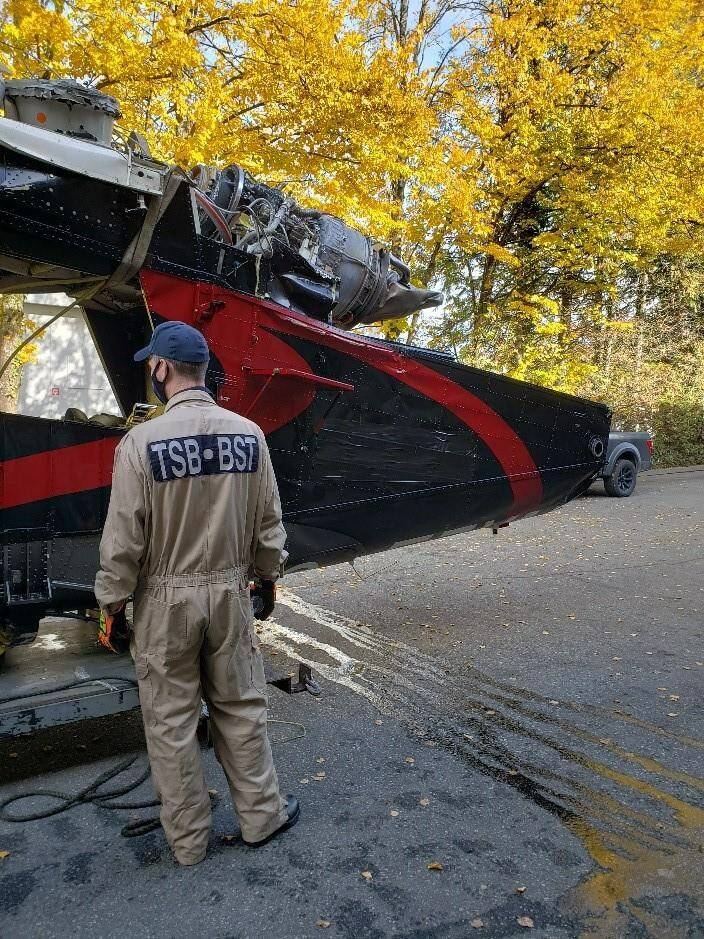 A Transportation Safety Board investigator looks over the wreckage of a Kaman KMax helicopter at the TSB hangar in Richmond, B.C. in this recent handout photo. The Transportation Safety Board says it has recovered the wreckage of a helicopter that crashed into the water off the Sunshine Coast, north of Vancouver, in early October. THE CANADIAN PRESS/HO, TSB *MANDATORY CREDIT*