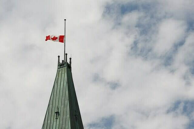 Heritage Canada says the national flag will remain at half-mast leading up to Remembrance Day instead of hoisting it up to be lowered again. The Canadian flag flies at half-mast on the Peace Tower at Parliament Hill on Canada Day in recognition of the discovery of unmarked graves of Indigenous children at residential schools. Thursday, July 1, 2021. THE CANADIAN PRESS/ Patrick Doyle