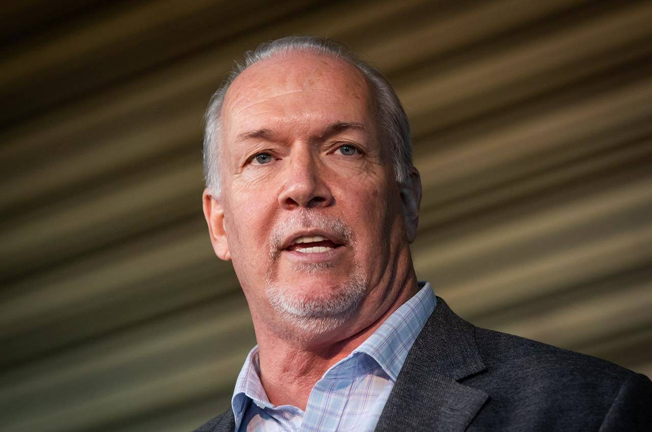 B.C. Premier John Horgan speaks in Vancouver, on Thursday, September 16, 2021. A statement from the British Columbia premier’s office says John Horgan is recovering well after undergoing biopsy surgery for a growth in his throat. THE CANADIAN PRESS/Darryl Dyck