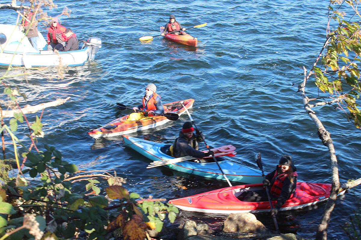 A protest flotilla gathers in the waters off 1 Port Dr. in Nanaimo, speaking against exporting of raw logs from Canada. (Karl Yu/News Bulletin)