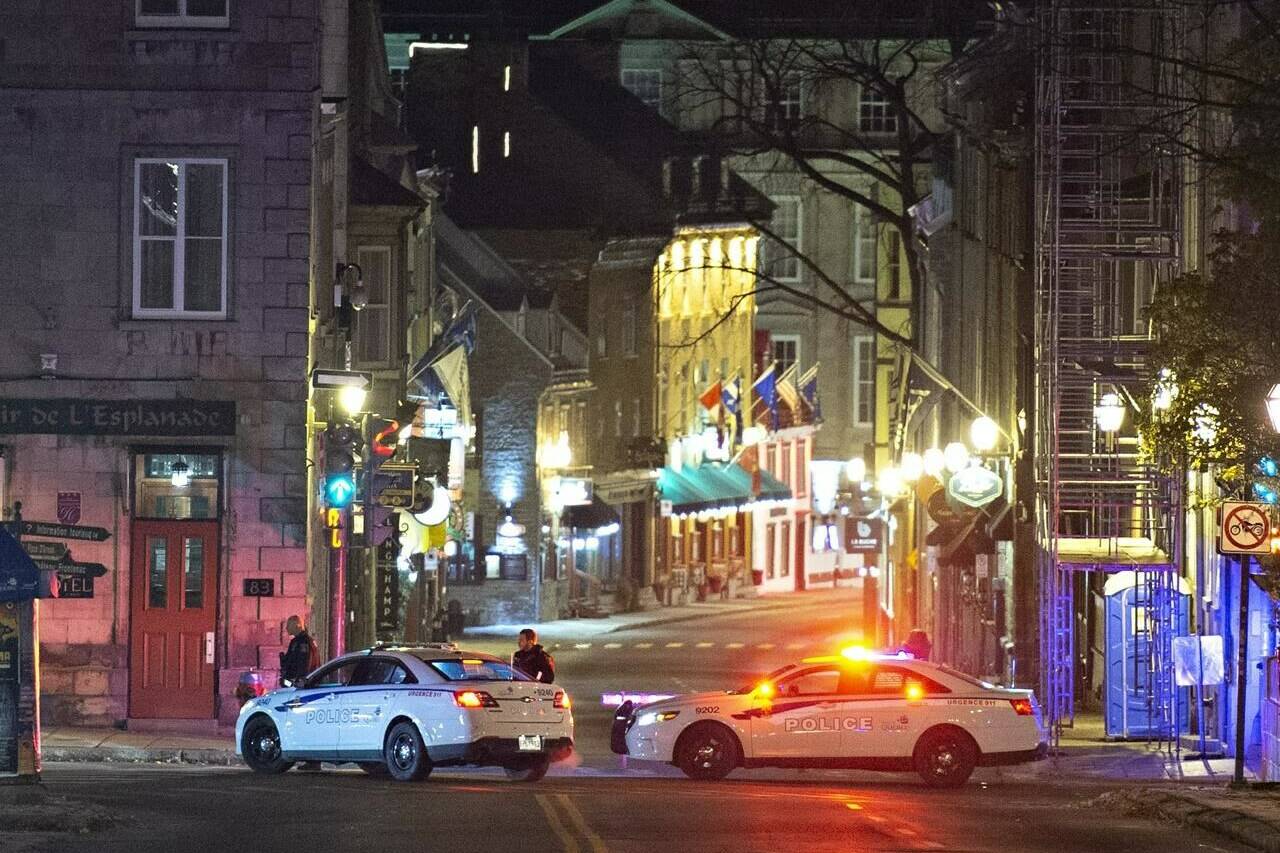 Police cars block the Saint-Louis Street near the Chateau Frontenac, early Sunday, November 1, 2020 in Quebec City. Quebec City is commemorating the victims and survivors of a fatal sword attack that left two dead and others injured on last year’s Halloween night. Hairdresser Suzanne Clermont, 61, and 56-year-old museum employee Francois Duchesne died in the Halloween-night attack that also left five others injured after a man dressed in a medieval costume and wielding a Japanese-style sword went on a rampage in Quebec City. THE CANADIAN PRESS/Jacques Boissinot