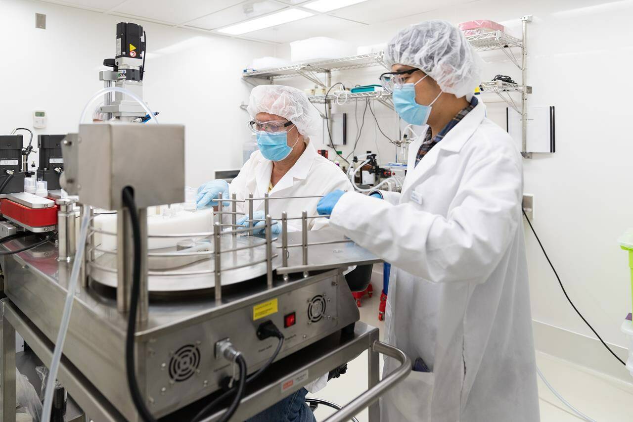 Dr. Raimar Lobenberg, director of Applied Pharmaceutical Innovation and University of Alberta professor, works with researcher Chulhun Park on an automated filling machine in a cleanroom used for clinical trial production in an undated handout photo. THE CANADIAN PRESS/HO-University of Alberta, *MANDATORY CREDIT*