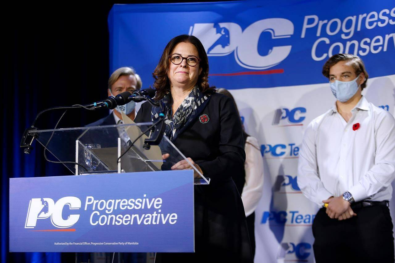 Manitoba’s newly elected Progressive Conservative leader and the province’s new premier, Heather Stefanson, speaks at a victory party after defeating Shelly Glover in a leadership race, as her family, from left, Jason, Victoria and Tommy, look on in Winnipeg on Oct. 30, 2021. THE CANADIAN PRESS/John Woods