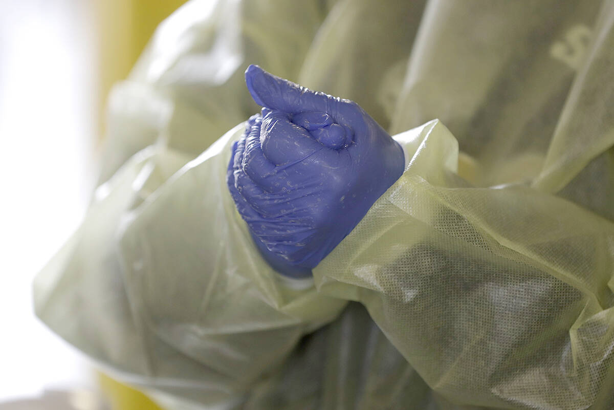 Employee at a drive-through COVID-19 testing centre, in Whitestown, Ind. (AP Photo/Darron Cummings)