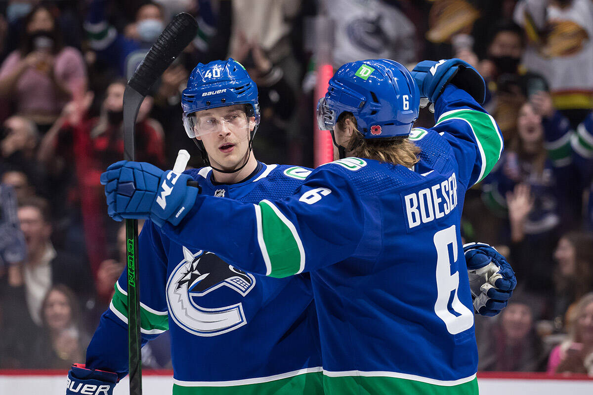 Vancouver Canucks’ Elias Pettersson, left, of Sweden, and Brock Boeser celebrate Pettersson’s goal against the Dallas Stars during the second period of an NHL hockey game in Vancouver, B.C., Sunday, Nov. 7, 2021. THE CANADIAN PRESS/Darryl Dyck