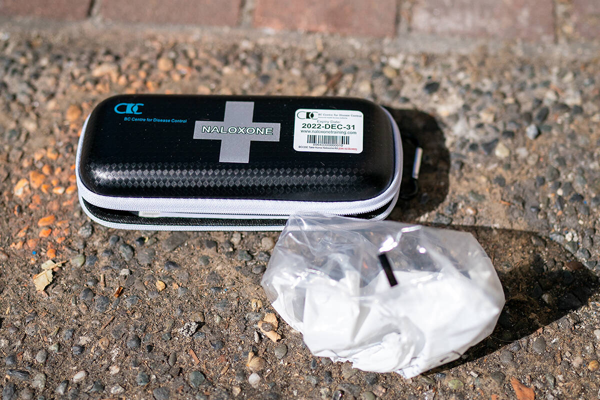 A used naloxone kit is seen on the sidewalk as paramedics from B.C. Ambulance respond to a drug overdose in downtown Vancouver, Wednesday, June 23, 2021. Over the past several years the drug overdoses not only across British Columbia but throughout Canada have but grown. On June, 23, 2021 for instance B.C. Ambulance paramedics responded to 140 overdose calls across the province with 42 of those being just in Vancouver. THE CANADIAN PRESS/Jonathan Hayward