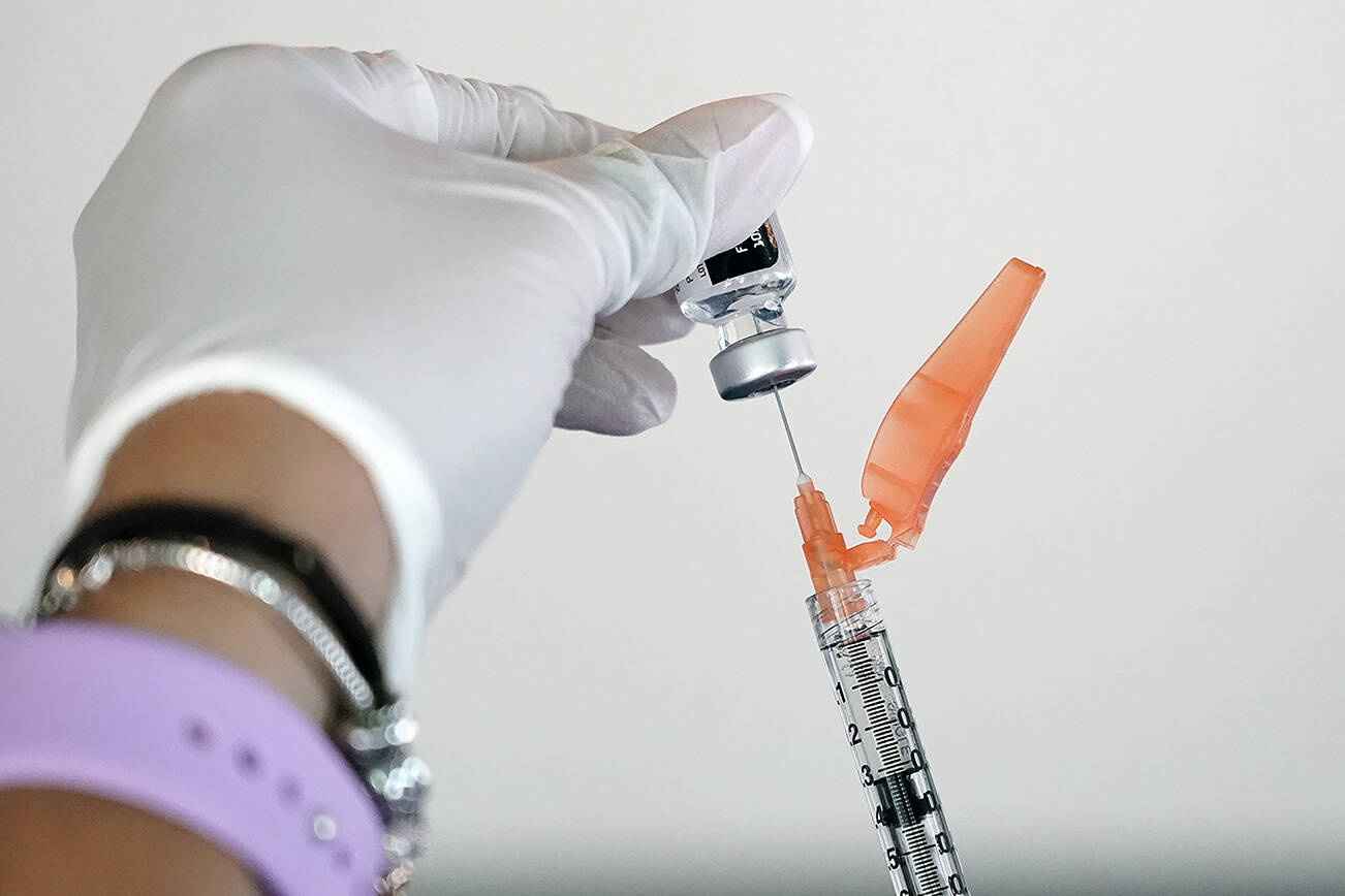 FILE - In this Tuesday, Sept. 21, 2021 file photo, a nurse loads a syringe with the Pfizer COVID-19 vaccine in Jackson, Miss. Millions of Americans are now eligible to receive a Pfizer booster shot to help increase their protection against the worst effects of the coronavirus. (AP Photo/Rogelio V. Solis)