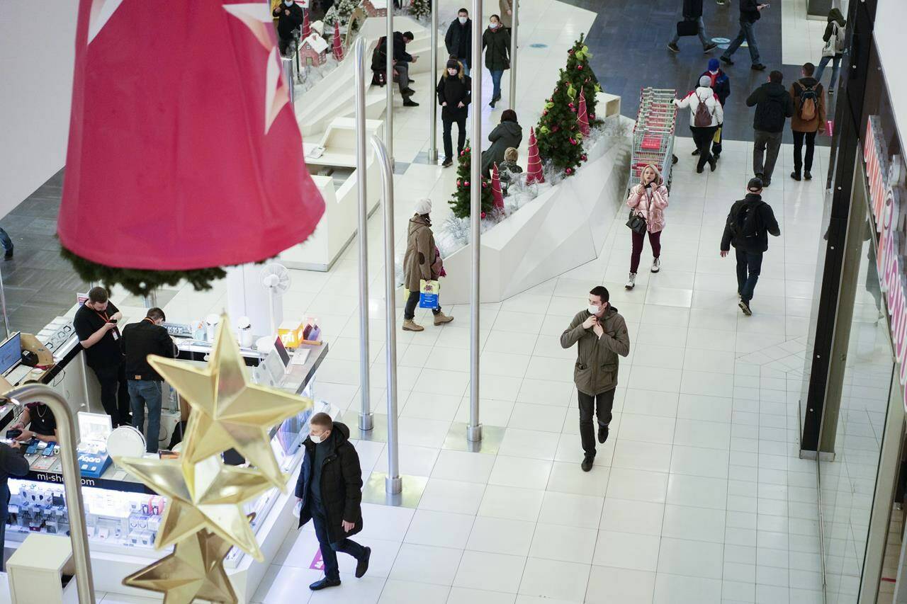 People visit a shopping mall in Moscow, Russia, Monday, Nov. 8, 2021. Russians have gone back to work after a nine-day break that was ordered by authorities to tame a record-breaking surge of coronavirus infections and deaths. Still, daily numbers of new cases and deaths have remained high throughout the non-working period. (AP Photo/Pavel Golovkin)