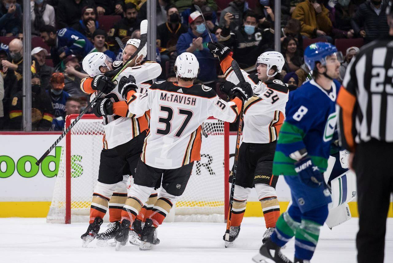 Anaheim Ducks’ Troy Terry, from left to right, Ryan Getzlaf, Mason McTavish, of Switzerland, and Jamie Drysdale celebrate Terry’s winning goal against the Vancouver Canucks during overtime NHL hockey action in Vancouver, on Tuesday, November 9, 2021. THE CANADIAN PRESS/Darryl Dyck