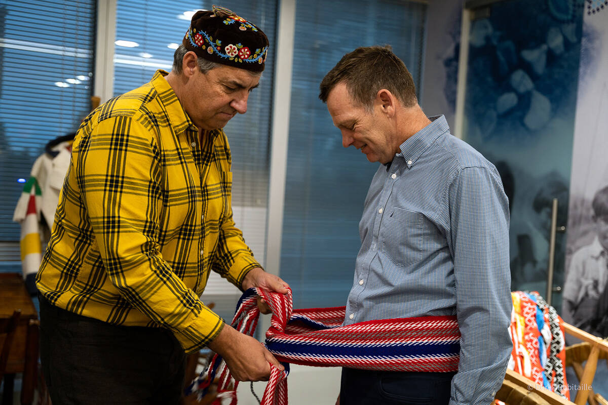 Louis De Jaeger, MNBC director for Region 2, ties the commemorative Terry Fox sash onto Terry’s brother, Darrell Fox. (Métis Nation B.C.)