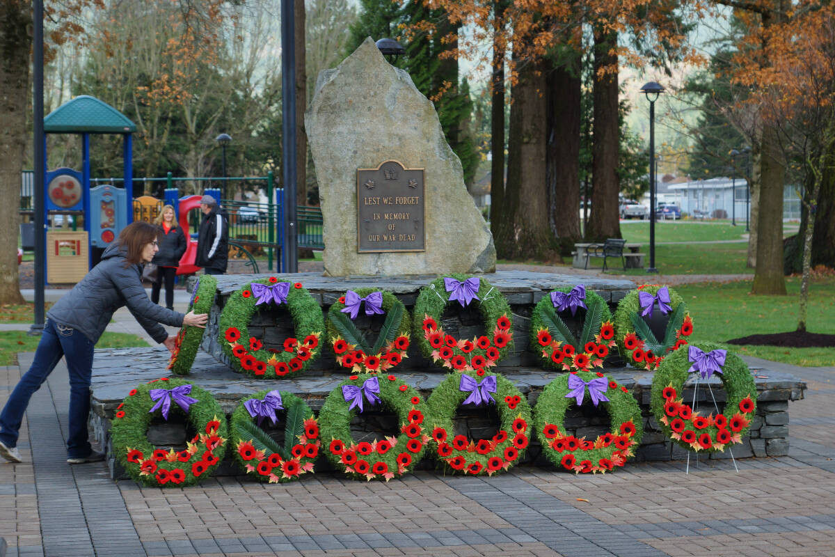 A woman lays a wreath at the cenotaph in Hope on Remembrance Day. (Bill Dobbs photo)