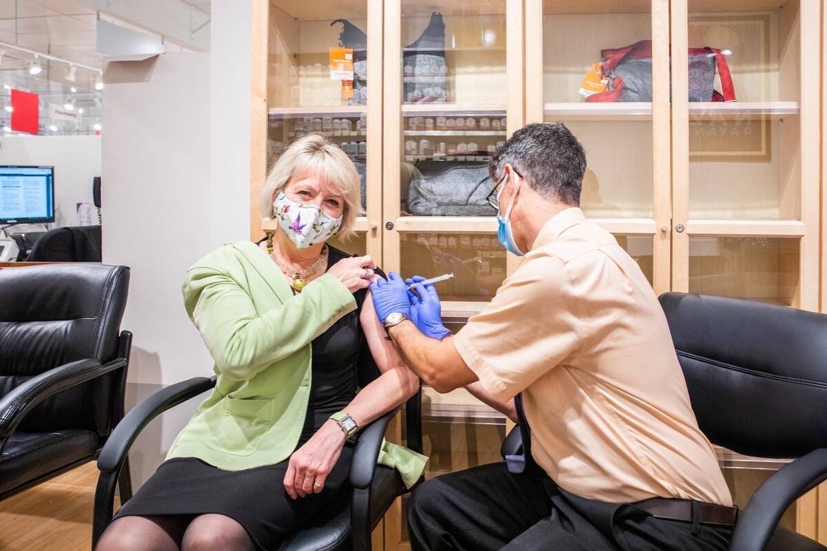 Provincial health officer Dr. Bonnie Henry receives seasonal influenza vaccination, Oct. 18, 2021. The health ministry is urging every adult to get a free flu shot from a local pharmacy as it prepares for booster third doses of COVID-19 vaccine this winter. (B.C. government photo)