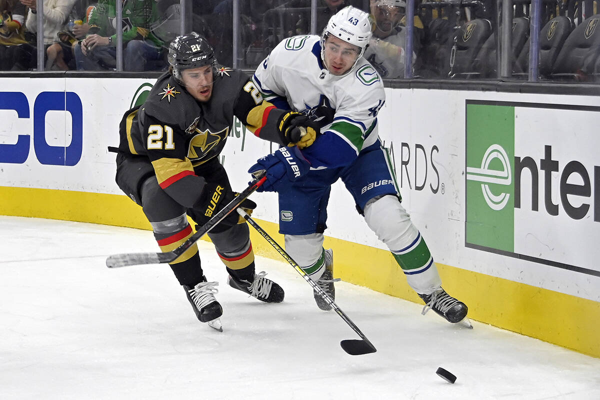Vegas Golden Knights centre Brett Howden (21) and Vancouver Canucks defenceman Quinn Hughes (43) chase the puck during the second period of an NHL hockey game Saturday, Nov. 13, 2021, in Las Vegas. (AP Photo/David Becker)
Vegas Golden Knights centre Brett Howden (21) and Vancouver Canucks defenceman Quinn Hughes (43) chase the puck during the second period of an NHL hockey game Saturday, Nov. 13, 2021, in Las Vegas. (AP Photo/David Becker)