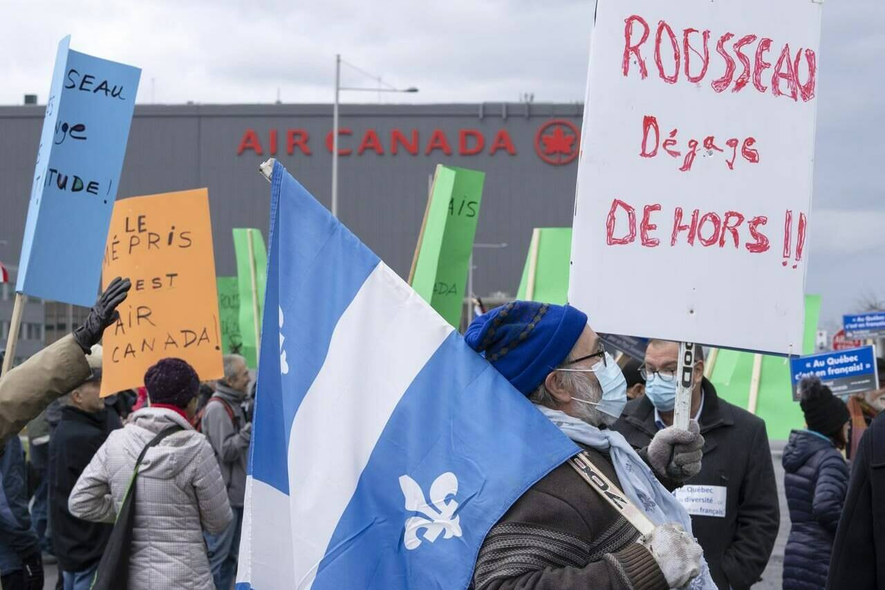 French language advocates protest Air Canada’s chief executive Michael Rousseau’s inability to speak French in front of the airline’s head office during a demonstration in Montreal, Saturday, Nov. 13, 2021. Roughly 100 demonstrators are demanding the departure of Air Canada CEO Michael Rousseau, enduring the November rain to stage a protest in front of the company’s head office in Montreal this afternoon. THE CANADIAN PRESS/Ryan Remiorz