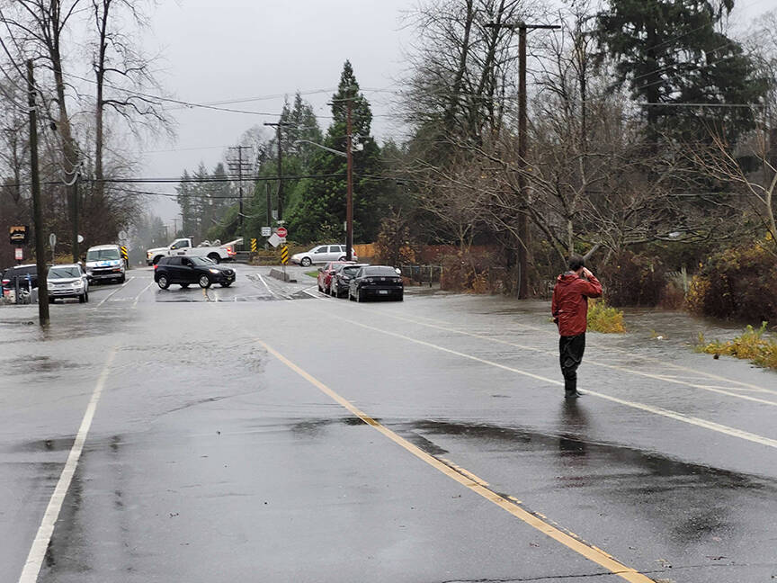 Residents took to street to help redirect cars and alert motorists of closures at 132nd Ave. (Neil Corbett/The News)