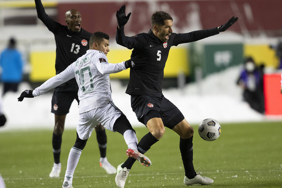 Canada’s Steven Vitória (5) and Mexico’s Orbelin Pineda Alvarado (10) via for the ball during World Cup Qualifiers in Edmonton, Tuesday, Nov. 16, 2021. THE CANADIAN PRESS/Jason Franson
