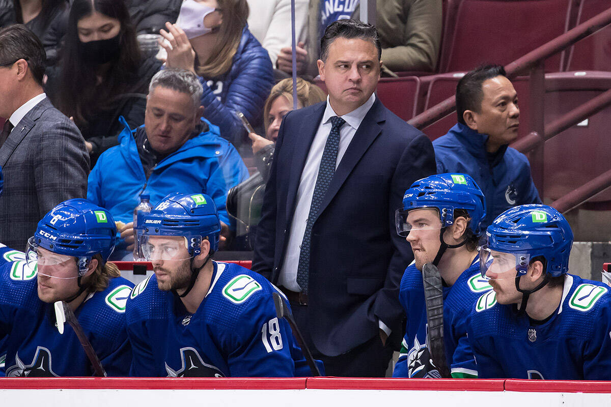 Vancouver Canucks head coach Travis Green, back, stands on the bench behind Brock Boeser, from left to right, Jason Dickinson, Juho Lammikko, of Finland, and Tyler Motte during the second period of an NHL hockey game against the Colorado Avalanche in Vancouver, on Wednesday, November 17, 2021. THE CANADIAN PRESS/Darryl Dyck